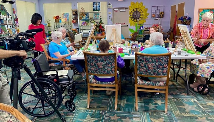 Residents painting in a colorful common area