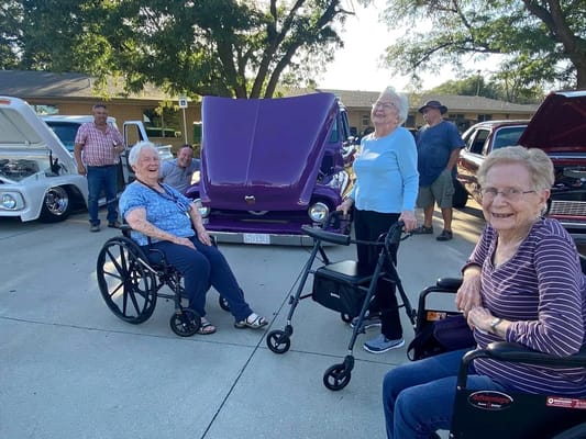 Residents enjoying a car show event outdoors