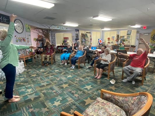 Residents participating in an exercise class indoors
