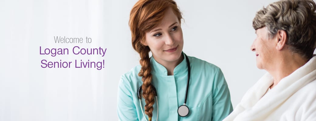 A caregiver smiling with a resident in a bright room