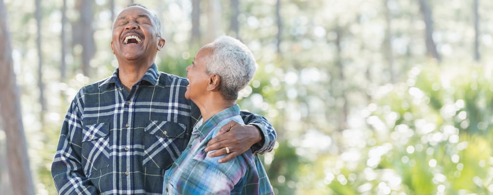 Couple laughing together in a natural outdoor setting