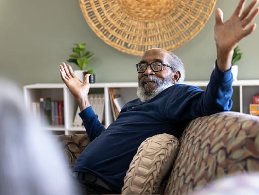 Resident enjoying a conversation in a lounge area