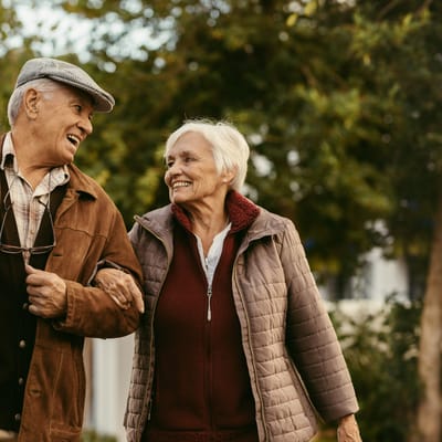 A senior couple walking together outdoors