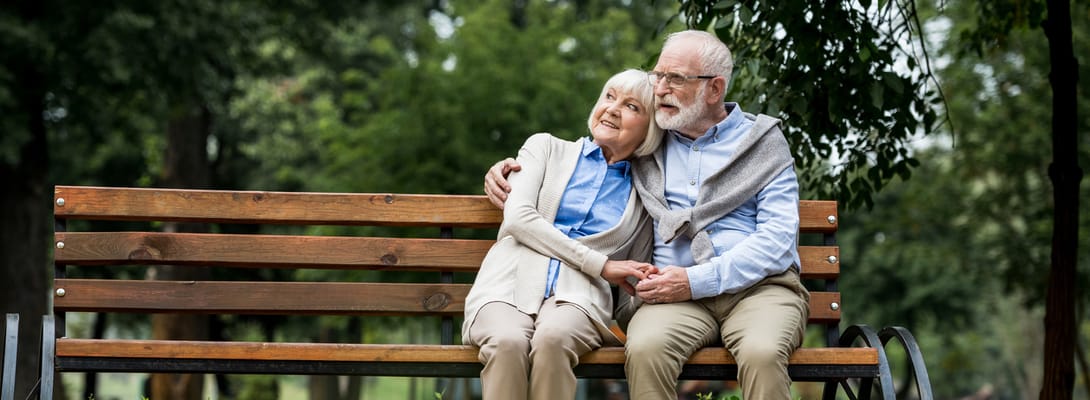 Senior couple enjoying a moment on a park bench