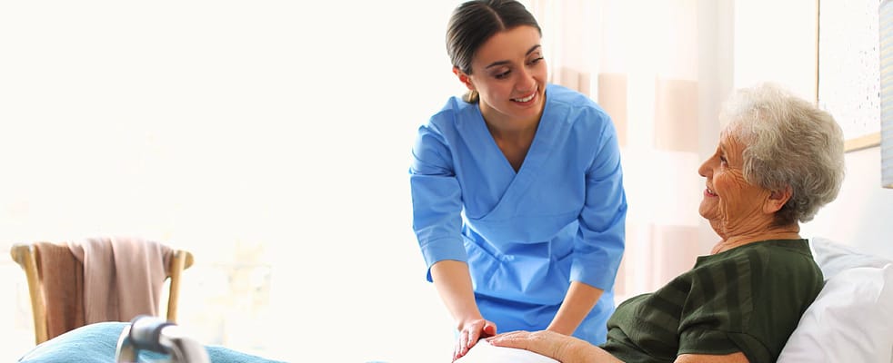 Nurse assisting a resident in a bright room