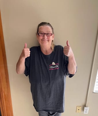 A resident giving thumbs up in a well-lit room