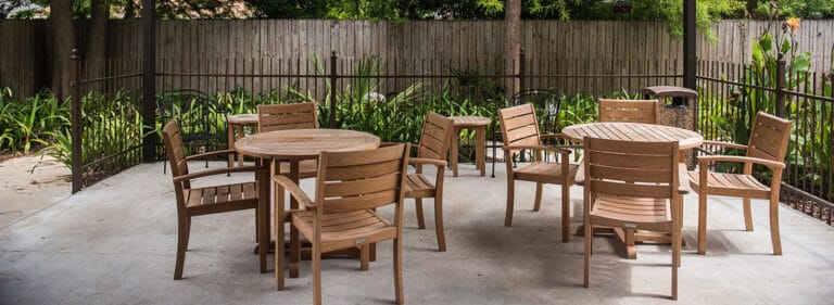 Outdoor seating area with wooden chairs and tables