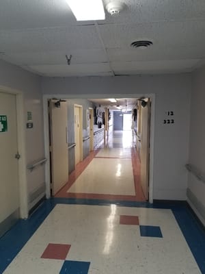 Long corridor with light fixtures and numbered doors