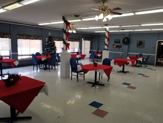 Dining area decorated for the holidays with tables