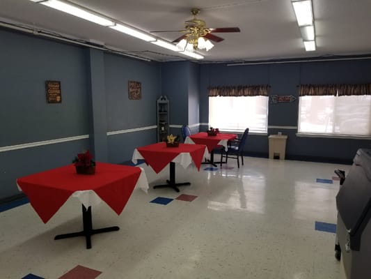 Bright interior space with red tablecloths and seating