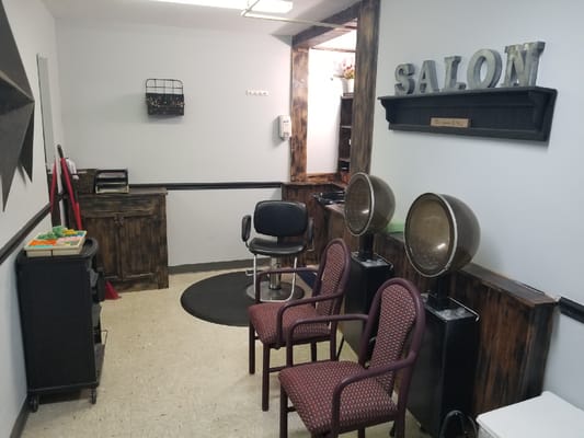 Interior view of a salon with chairs and styling equipment
