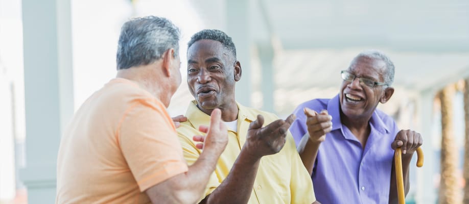 Three men engaged in a cheerful conversation
