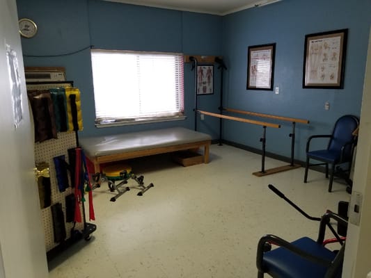 Physical therapy room with exercise equipment