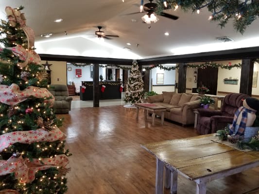 Common area decorated for the holidays with Christmas trees