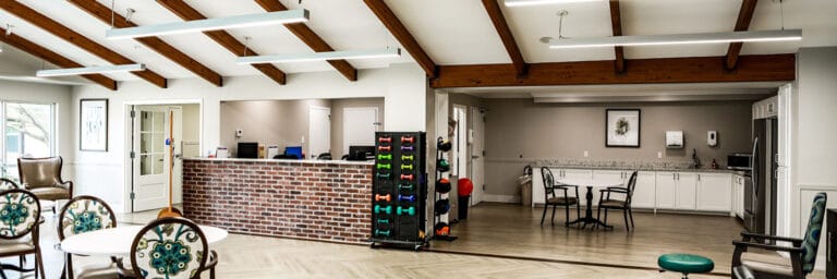 Bright common area with seating and exercise equipment