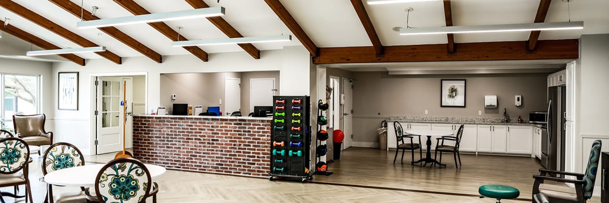 Bright common area with seating and exercise equipment