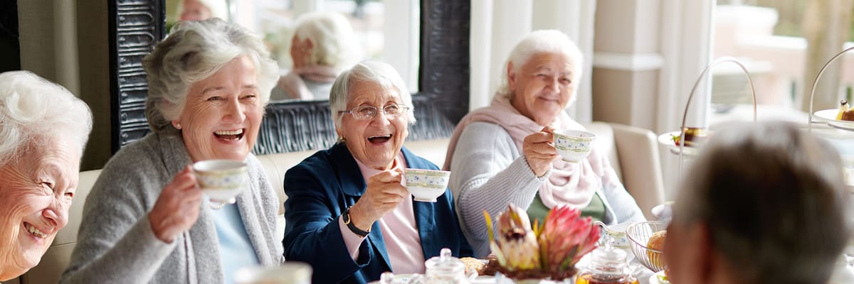 Residents enjoying tea and socializing in a common area