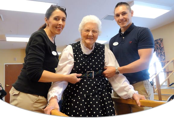 Staff assisting a resident in a bright interior