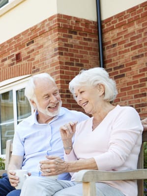 Couple enjoying a conversation on a bench outside