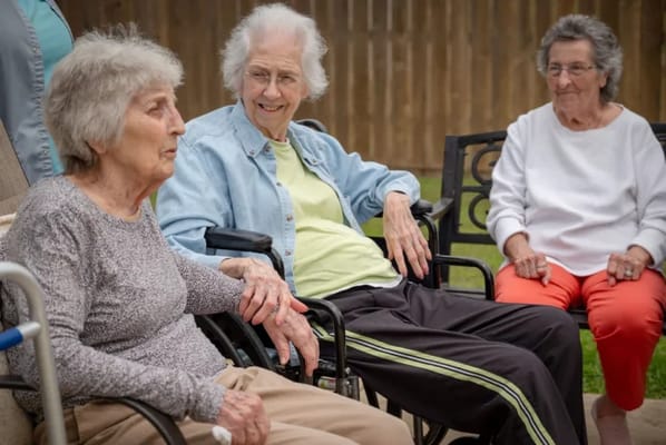 Residents enjoying time outdoors in wheelchairs