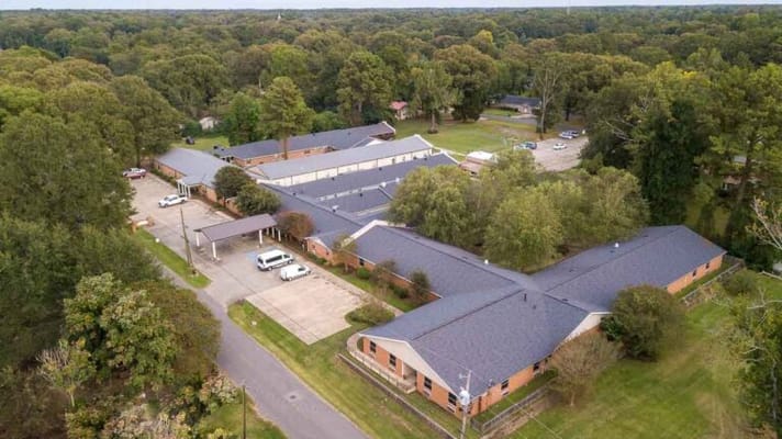 Aerial view of a senior living facility surrounded by trees