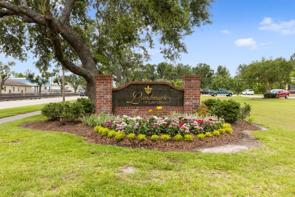 Signage for Landmark of Lake Charles with landscaping