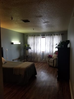 Cozy private room with a bed and chair