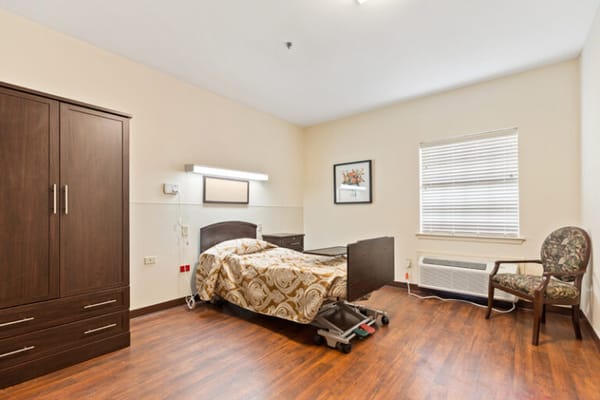 Bright private room with a bed and chair