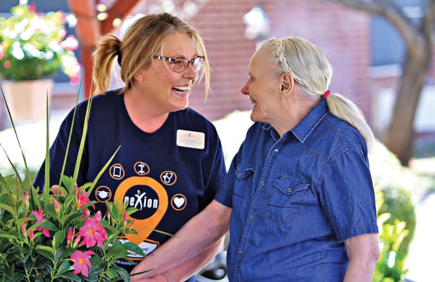 Staff member and resident enjoying time together outdoors