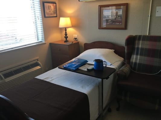 Cozy resident room with a bed and lamp