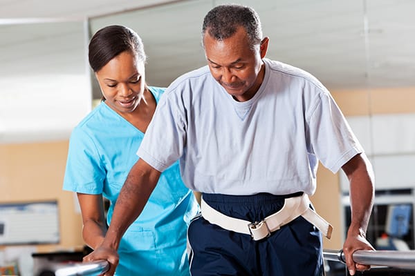 A caregiver assisting a resident during therapy