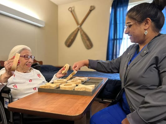 Resident engaging in a hands-on activity with staff