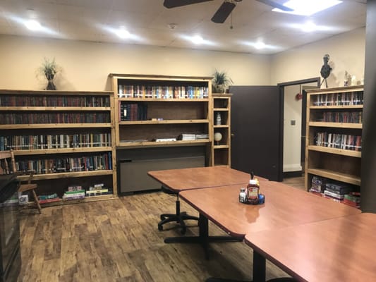 Interior view of a library with bookshelves and tables