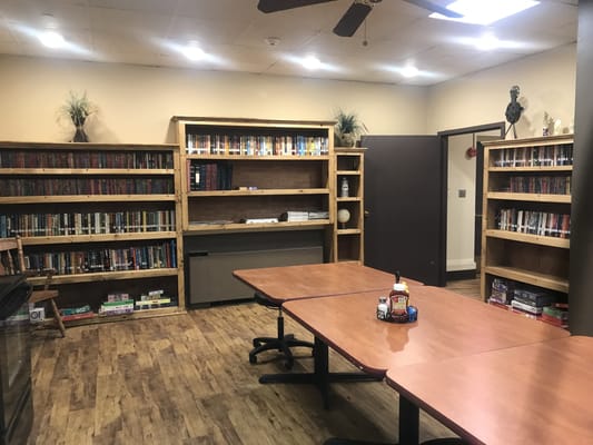 Interior view of a library with bookshelves and tables