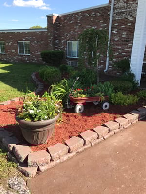 Flower bed with a wagon in a garden area