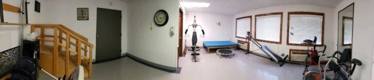 Interior view of a therapy room with exercise equipment