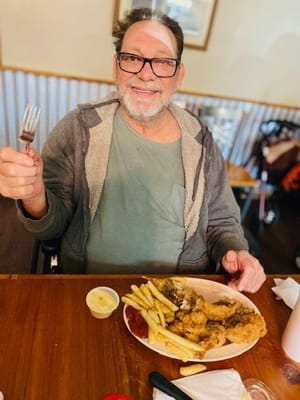 Resident enjoying a meal in the dining area