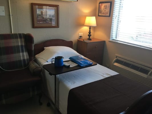 Cozy resident room with bed and chair