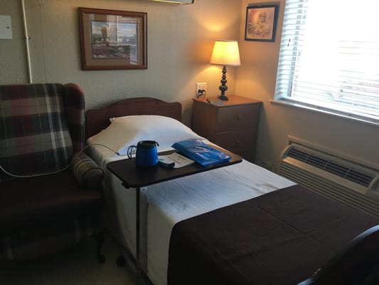 Cozy resident room with bed and chair