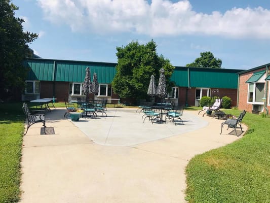 Outdoor seating area with tables and umbrellas