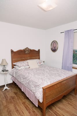 Cozy bedroom with a large wooden bed and decorative bedding