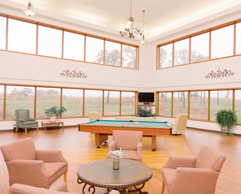 Common area with pool table and large windows