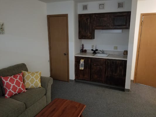 Cozy interior of a resident's room with a kitchenette
