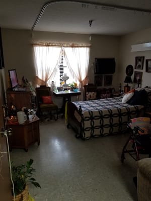 Cozy resident room with personal decorations and a bed