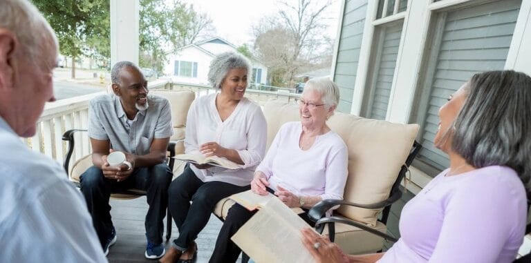Residents enjoying a gathering on a porch