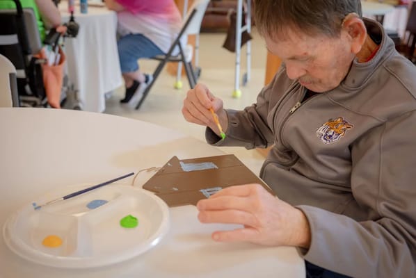 Resident painting during an art activity session