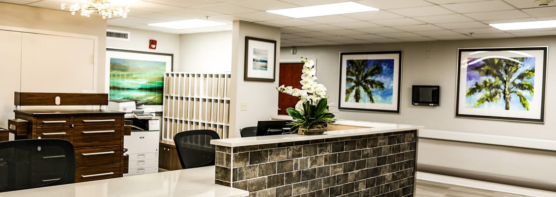 Bright reception area with artwork and decorative plants