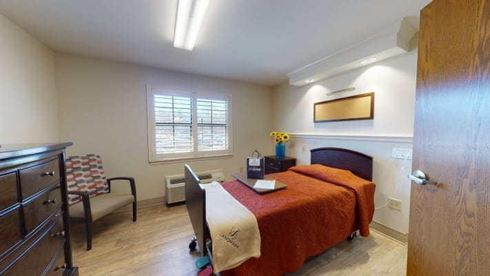 Cozy resident room with two beds and a chair