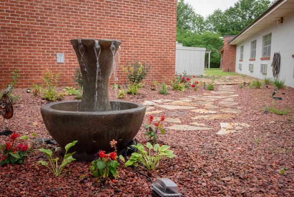 Tranquil garden area with a fountain and pathway