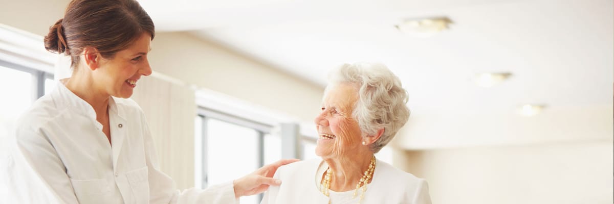 Staff member interacting joyfully with a resident
